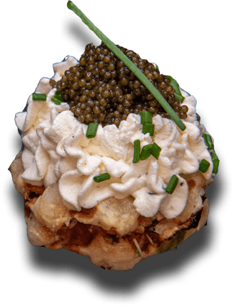 Savory waffle topped with caviar and cream